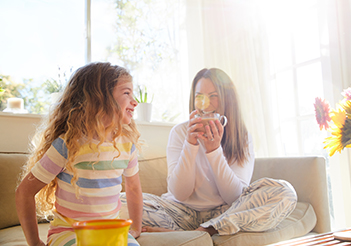 mom and young daughter sitting in their pajamas_351x246.