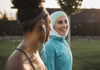 two-women-walking-and-smiling.